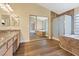 Bathroom with tile floors, walk-in shower, soaking tub and double vanity with granite counters at 7808 Brook Valley Dr, Las Vegas, NV 89123