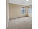Neutral bedroom featuring a large window that provides lots of natural light and neutral carpet at 7808 Brook Valley Dr, Las Vegas, NV 89123