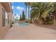 Backyard view features an in-ground pool, deck, and lush landscaping at 7808 Brook Valley Dr, Las Vegas, NV 89123