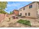 Spacious backyard featuring a patio area with outdoor seating, a hot tub, and low-maintenance landscaping at 7898 Red Rock Ridge Ave, Las Vegas, NV 89179