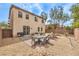 Backyard with a patio area, a built-in fire pit, a hot tub, desert landscaping, and a privacy fence at 7898 Red Rock Ridge Ave, Las Vegas, NV 89179