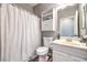 This bathroom includes a vanity cabinet, sink, mirror, and shower with a white curtain at 7898 Red Rock Ridge Ave, Las Vegas, NV 89179