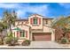 Beautiful two-story home featuring a well-kept yard, a two-car garage, and an inviting facade at 7898 Red Rock Ridge Ave, Las Vegas, NV 89179