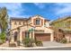 Attractive two-story home with solar panels, a two-car garage, and desert landscaping at 7898 Red Rock Ridge Ave, Las Vegas, NV 89179