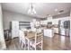 Charming kitchen boasts stainless steel appliances, granite counters, island, and an adjacent dining area at 7898 Red Rock Ridge Ave, Las Vegas, NV 89179