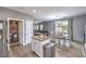 Charming kitchen with island, dining area, stainless steel fridge, and access to a walk-in pantry at 7898 Red Rock Ridge Ave, Las Vegas, NV 89179