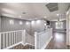 Upstairs landing featuring wood floors, white railing, and ample natural light streaming through multiple windows at 7898 Red Rock Ridge Ave, Las Vegas, NV 89179