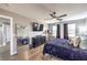 Main bedroom with a ceiling fan, hardwood floors, a walk in closet, and purple accents at 7898 Red Rock Ridge Ave, Las Vegas, NV 89179