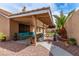 Inviting backyard patio with comfortable seating, mature trees, and well-manicured lawn at 805 Blue Springs Dr, Henderson, NV 89002