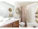 Bathroom featuring decorative accents, wood cabinet, and shower with decorative curtain at 805 Blue Springs Dr, Henderson, NV 89002