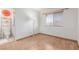 Cozy bedroom featuring wood floors, a window with blinds, and an attached bathroom at 805 Blue Springs Dr, Henderson, NV 89002