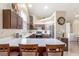 Bright and spacious kitchen featuring stainless steel appliances, dark wood cabinetry, and a breakfast bar at 805 Blue Springs Dr, Henderson, NV 89002