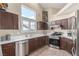 Well-equipped kitchen boasts stainless steel appliances, dark wood cabinets, and sleek countertops at 805 Blue Springs Dr, Henderson, NV 89002