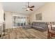 Contemporary living room enhanced by wood-style flooring, a fireplace, and patio access at 805 Blue Springs Dr, Henderson, NV 89002