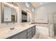 Modern bathroom with double sinks, soaking tub, and tiled floors at 8141 Guava Nectar Ave, Las Vegas, NV 89131
