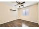 Bedroom with dark-toned wood flooring, a ceiling fan, and a floating shelf at 8141 Guava Nectar Ave, Las Vegas, NV 89131