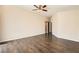 Large bedroom featuring wood floors, ceiling fan, and an ensuite bathroom at 8141 Guava Nectar Ave, Las Vegas, NV 89131