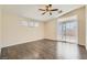Spacious bedroom with ceiling fan, wood floors, and access to the outdoor area at 8141 Guava Nectar Ave, Las Vegas, NV 89131