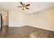 Bright bedroom featuring wood floors, ceiling fan, and multiple windows for natural light at 8141 Guava Nectar Ave, Las Vegas, NV 89131