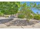 Well-maintained single-story home with desert landscaping, mature trees, and a welcoming walkway at 8141 Guava Nectar Ave, Las Vegas, NV 89131