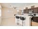 Open concept kitchen featuring a breakfast bar, stainless steel appliances, and seamless flow to living area at 8141 Guava Nectar Ave, Las Vegas, NV 89131
