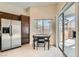 Bright eat-in kitchen area with stainless steel refrigerator and access to outdoor patio at 8141 Guava Nectar Ave, Las Vegas, NV 89131
