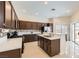 Well-appointed kitchen with dark cabinetry, mosaic backsplash, quartz countertops, and stainless steel appliances at 8141 Guava Nectar Ave, Las Vegas, NV 89131