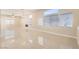 Bright and airy living room featuring tile floors, large windows, and stylish lighting fixtures at 8141 Guava Nectar Ave, Las Vegas, NV 89131