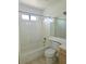 Bright bathroom featuring white tiled walls, a bathtub, and a single sink vanity at 8452 Boseck Dr # 216, Las Vegas, NV 89145
