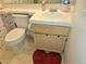 Cozy bathroom featuring a toilet, sink with cabinet, and heart-shaped rug at 8452 Boseck Dr # 216, Las Vegas, NV 89145