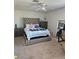 Bedroom showcasing a tufted headboard bed, carpeted floors, and ample natural light at 8452 Boseck Dr # 216, Las Vegas, NV 89145