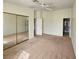 Neutral bedroom with mirrored closet doors and ample natural light at 8452 Boseck Dr # 216, Las Vegas, NV 89145