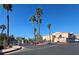 Gated community entrance with palm trees and well-maintained landscaping at 8452 Boseck Dr # 216, Las Vegas, NV 89145