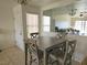 Dining area featuring a gray dining table with four chairs and tiled flooring at 8452 Boseck Dr # 216, Las Vegas, NV 89145