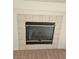 Close-up of a fireplace with tile border and dark mesh screen at 8452 Boseck Dr # 216, Las Vegas, NV 89145