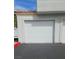 Exterior of the property showing a one-car garage door with a multi-paneled design at 8452 Boseck Dr # 216, Las Vegas, NV 89145