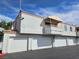 A row of well-maintained garage doors is visible in the exterior shot of the homes at 8452 Boseck Dr # 216, Las Vegas, NV 89145