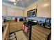 Kitchen featuring wood cabinets, granite countertops, and stainless steel appliances at 8452 Boseck Dr # 216, Las Vegas, NV 89145