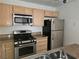 Well-equipped kitchen featuring stainless steel appliances and light wood cabinetry at 8452 Boseck Dr # 216, Las Vegas, NV 89145