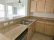 Kitchen features granite countertops, wood cabinets, and stainless steel sink at 8452 Boseck Dr # 216, Las Vegas, NV 89145