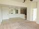 View of living room featuring carpet, tile flooring, and open access to kitchen and dining areas at 8452 Boseck Dr # 216, Las Vegas, NV 89145