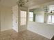 Open-concept dining room featuring tiled floor, chandelier, and view into living area at 8452 Boseck Dr # 216, Las Vegas, NV 89145