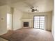 Spacious living room with a fireplace, carpet flooring, ceiling fan, and sliding door to patio at 8452 Boseck Dr # 216, Las Vegas, NV 89145