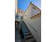 Exterior stairway with blue railing leading to the entrance of the home at 8452 Boseck Dr # 216, Las Vegas, NV 89145