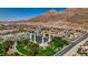Aerial neighborhood view featuring a local temple with residential homes and mountains in the background at 931 Temple View Dr, Las Vegas, NV 89110