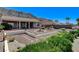 Large backyard with desert landscaping, fountain, and a covered patio, set against mountain views at 931 Temple View Dr, Las Vegas, NV 89110