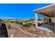 Beautifully landscaped backyard featuring a covered patio with gorgeous mountain views at 931 Temple View Dr, Las Vegas, NV 89110