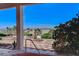 Scenic backyard view from a covered patio, highlighting a water fountain and distant city skyline at 931 Temple View Dr, Las Vegas, NV 89110