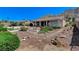 Expansive backyard with desert landscaping and a covered patio, perfect for outdoor entertaining at 931 Temple View Dr, Las Vegas, NV 89110