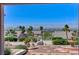 Elevated backyard view showcasing a landscaped yard with a water fountain and distant city views at 931 Temple View Dr, Las Vegas, NV 89110